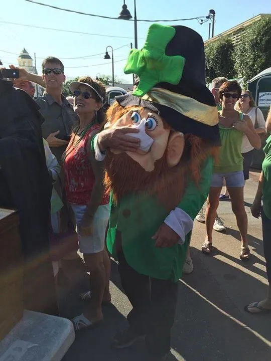 Fitzgerald's leprechaun mascot leading the St. Patrick's Day celebration