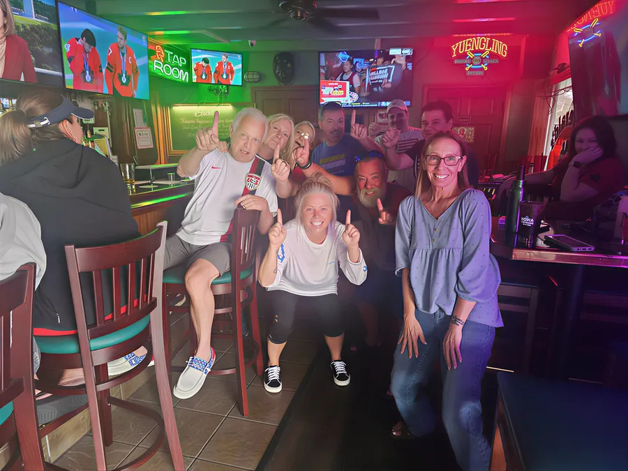 Sports fans watching the game on the HDTVs at the bar