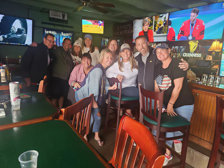 Friends enjoying drinks at the Fitzgerald's bar beneath Guinness signs